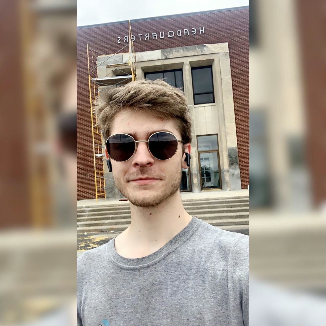 Younger Daniel Joseph Mueller outside a brick headquarters building