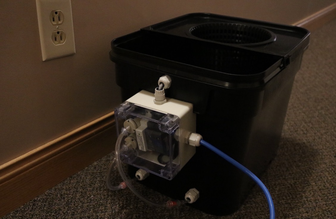 Daniel Mueller’s hydroponic grow unit with an attached clear electronics enclosure, tubing, and cables