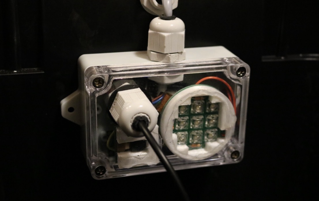 Close-up of the sensor control unit for Daniel Mueller’s hydroponic grow system inside a clear enclosure